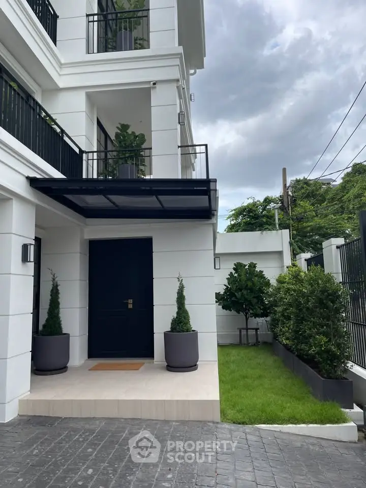 Elegant modern house exterior with lush greenery and stylish entrance