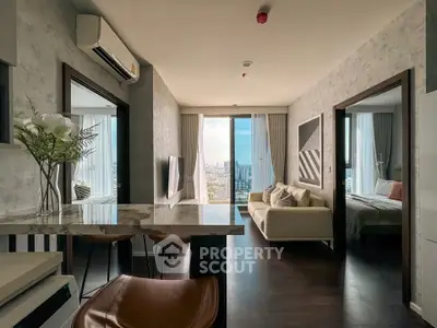 Modern apartment interior with open layout, featuring stylish living room and city view.
