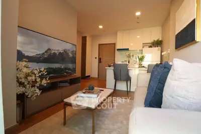 Modern living room with cozy seating and stylish decor in open layout apartment.