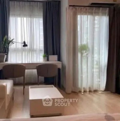 Modern living room with natural light, stylish furniture, and elegant decor.