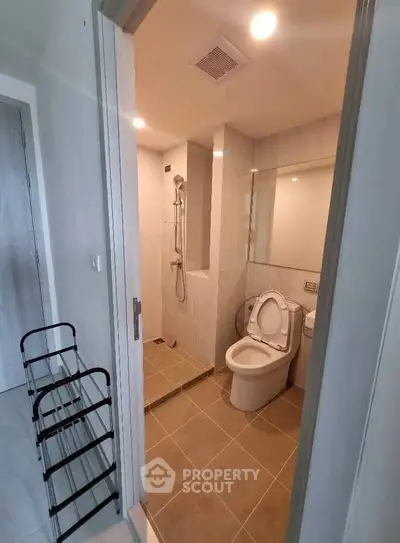 Modern bathroom with sleek design and shower area in contemporary apartment.