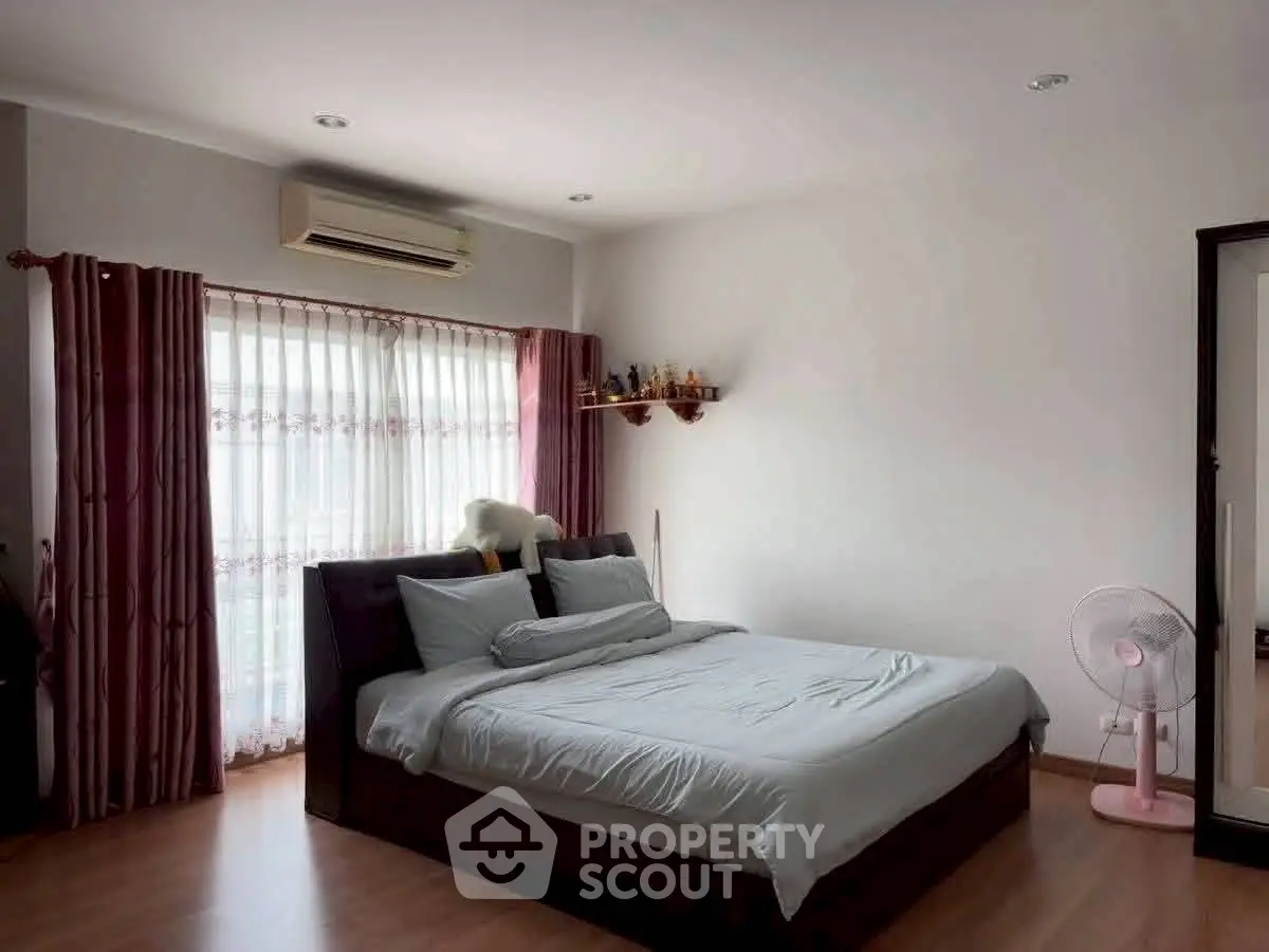Spacious bedroom with modern decor and natural light