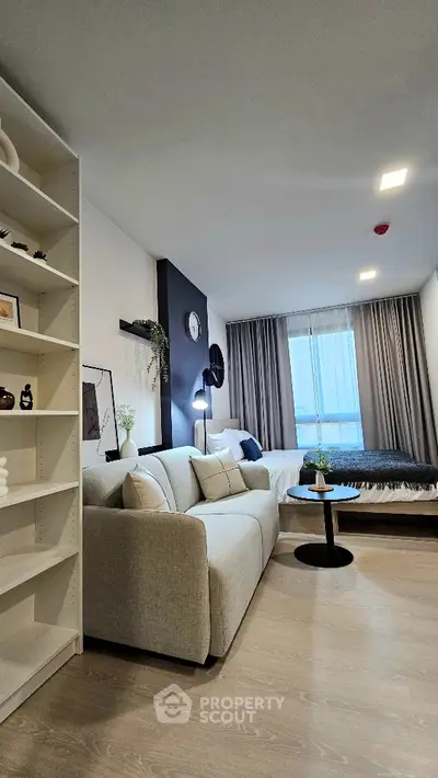 Modern living room with cozy sofa and stylish decor in a bright apartment.