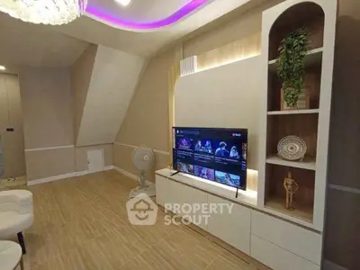 Modern living room with stylish TV setup and elegant lighting