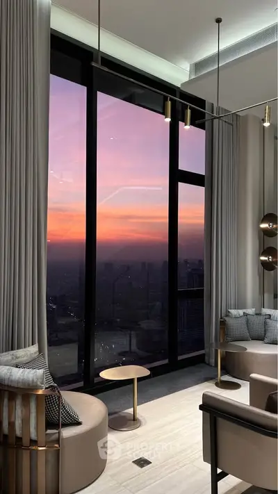 Luxurious living room with floor-to-ceiling windows offering stunning sunset city views.