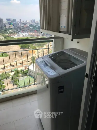 High-rise balcony with washing machine and cityscape view