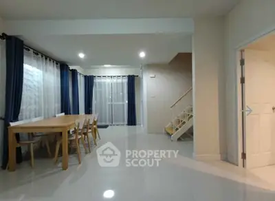 Spacious dining area with modern decor and staircase in a stylish home