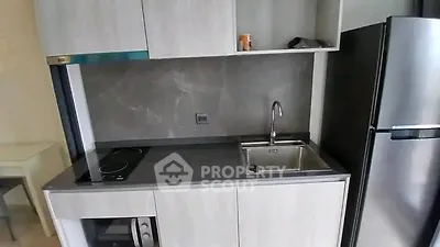 Modern compact kitchen with sleek cabinetry and stainless steel appliances