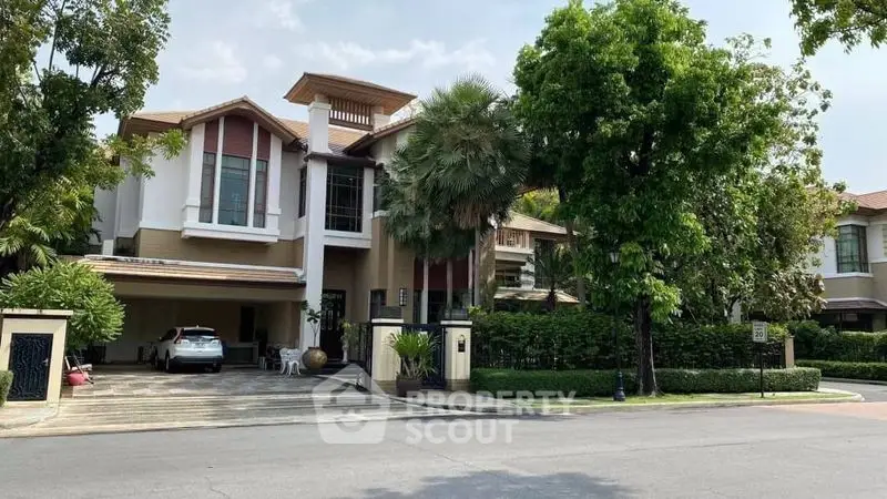 Luxurious modern house with lush greenery and spacious driveway