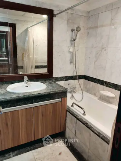 Luxurious marble bathroom with elegant wooden vanity and modern fixtures