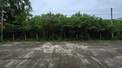 Vacant land plot with lush greenery, ideal for development or investment opportunities.