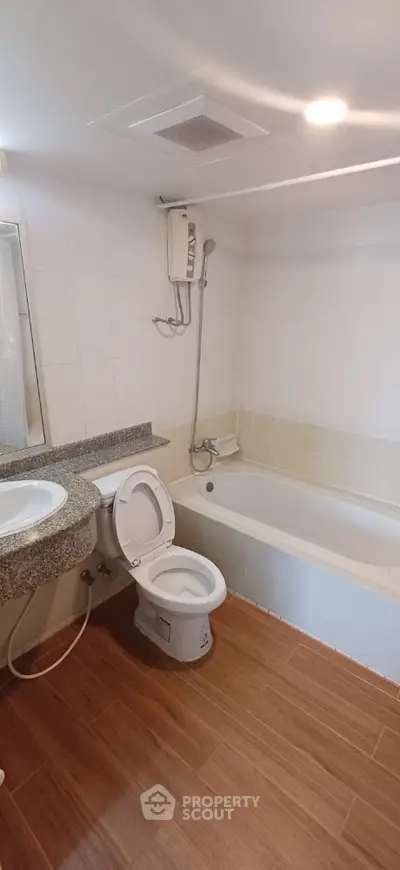 Modern bathroom with bathtub and sleek fixtures in a stylish apartment.