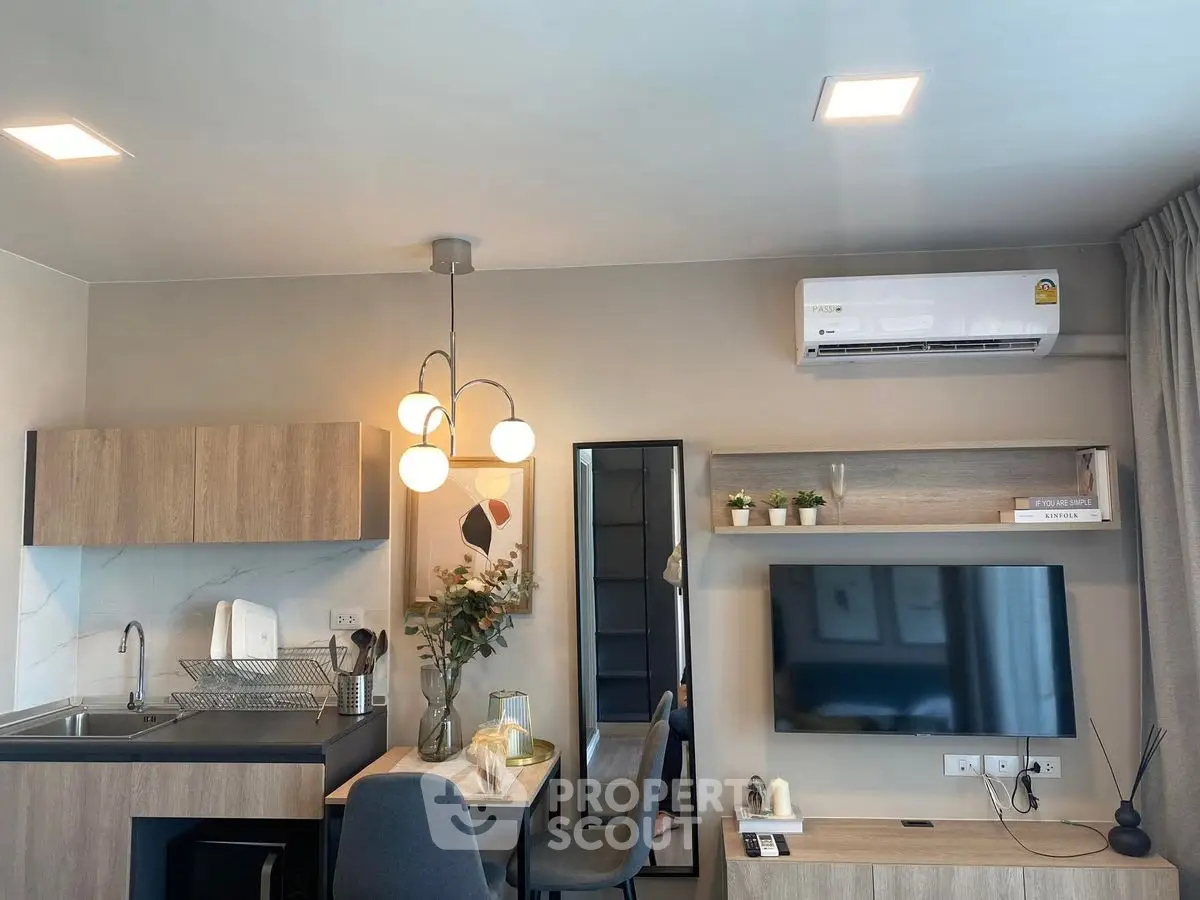 Modern living room with stylish decor and compact kitchen area