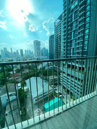 Stunning city view from high-rise balcony with modern skyscrapers.