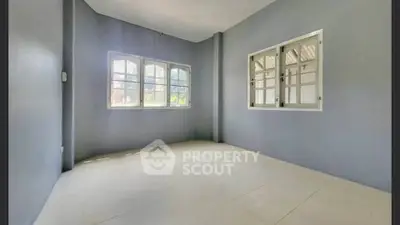Spacious empty room with large windows and tiled floor, perfect for customization.