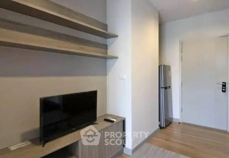 Modern living room with sleek TV stand and stainless steel fridge