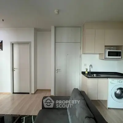 Modern apartment interior with sleek kitchen and washing machine