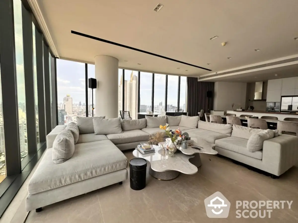 Luxurious modern living room with panoramic city views and elegant furnishings.