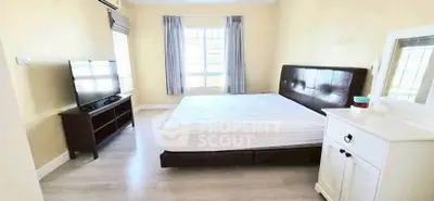 Spacious bedroom with modern furnishings and natural light