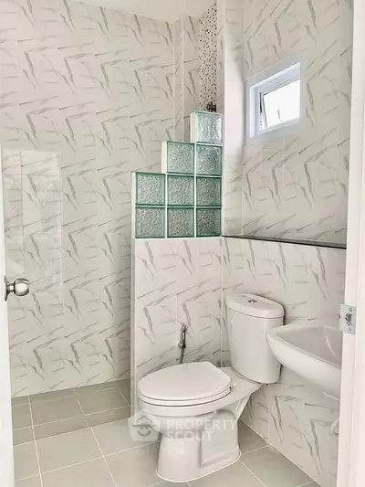 Modern bathroom with sleek design and glass block accents