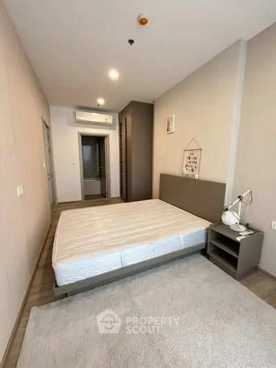 Spacious modern bedroom with minimalist design and ample natural light
