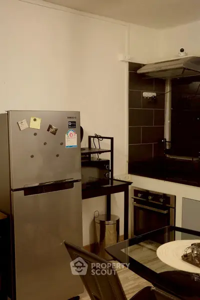 Modern kitchen with stainless steel appliances and sleek black accents, perfect for culinary enthusiasts.