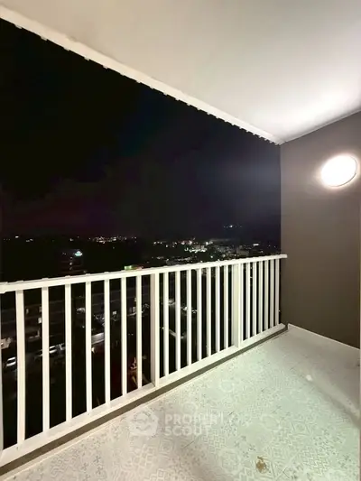 Spacious balcony with stunning night city view, perfect for relaxation and entertaining.