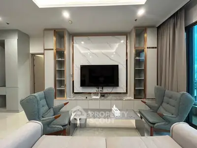 Modern living room with stylish furniture and large TV, perfect for relaxation and entertainment.