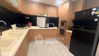 Modern kitchen with sleek wooden cabinets and built-in appliances