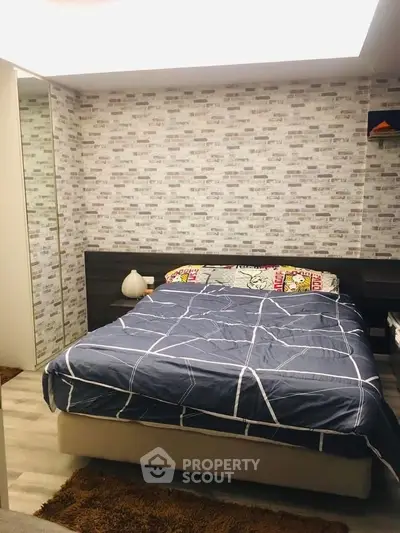Cozy bedroom with modern decor and stylish brick-patterned wallpaper