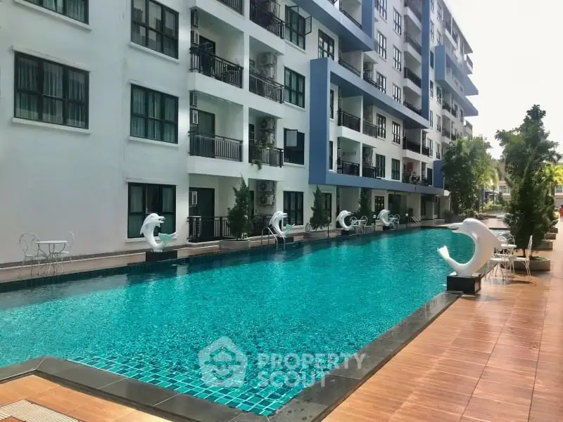 Modern apartment building with a stunning outdoor pool and stylish design.