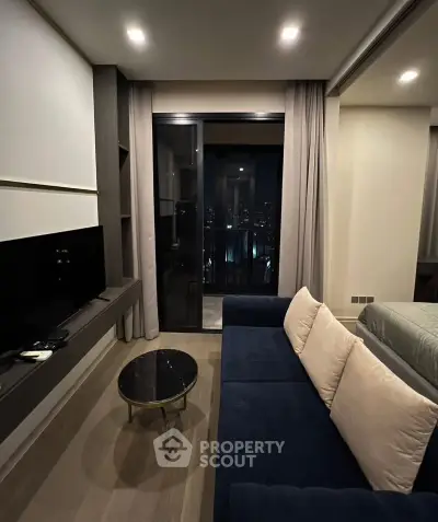 Modern living room with city view, sleek furniture, and cozy ambiance in urban apartment.