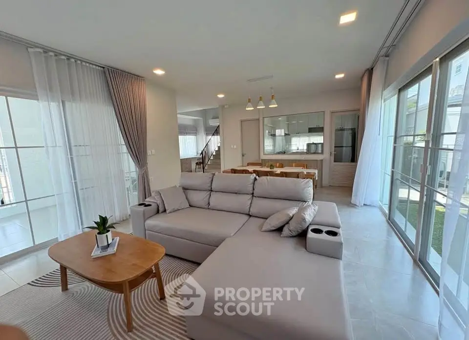 Spacious modern living room with open kitchen and large windows