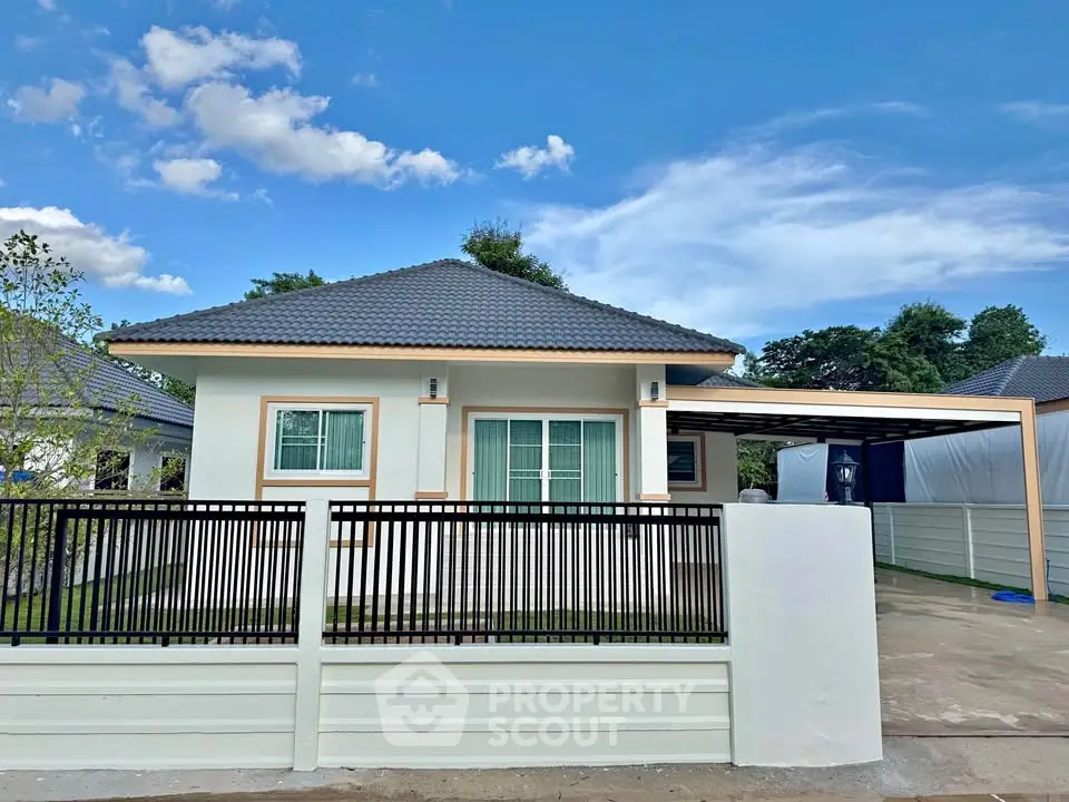Charming single-story house with modern design and spacious driveway in serene neighborhood.