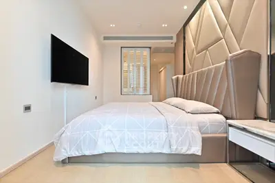 Luxurious modern bedroom with stylish decor and wall-mounted TV