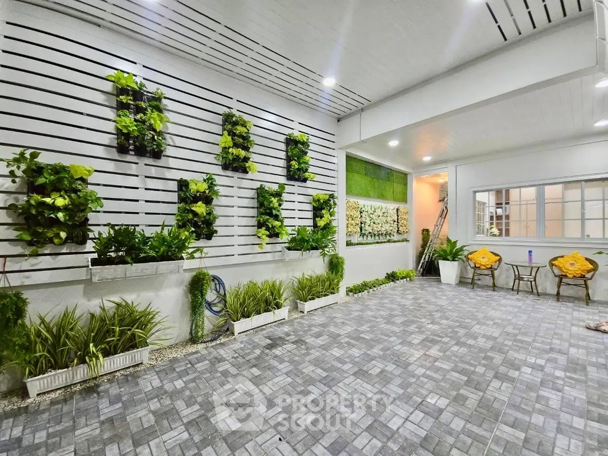 Charming garden patio with vertical plant wall and cozy seating area