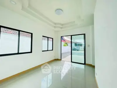 Bright and spacious room with large windows and glossy tiled floor, perfect for modern living.