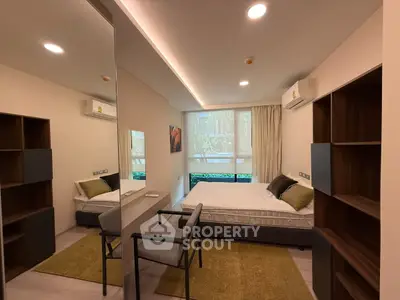 Modern bedroom with stylish decor, featuring a comfortable bed, built-in shelves, and large window for natural light.