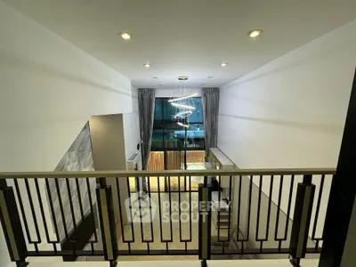 Modern loft-style living room with high ceiling and elegant lighting