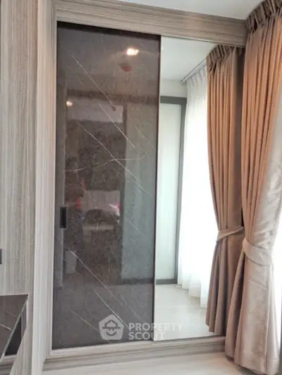 Modern bedroom with elegant sliding closet and floor-to-ceiling curtains