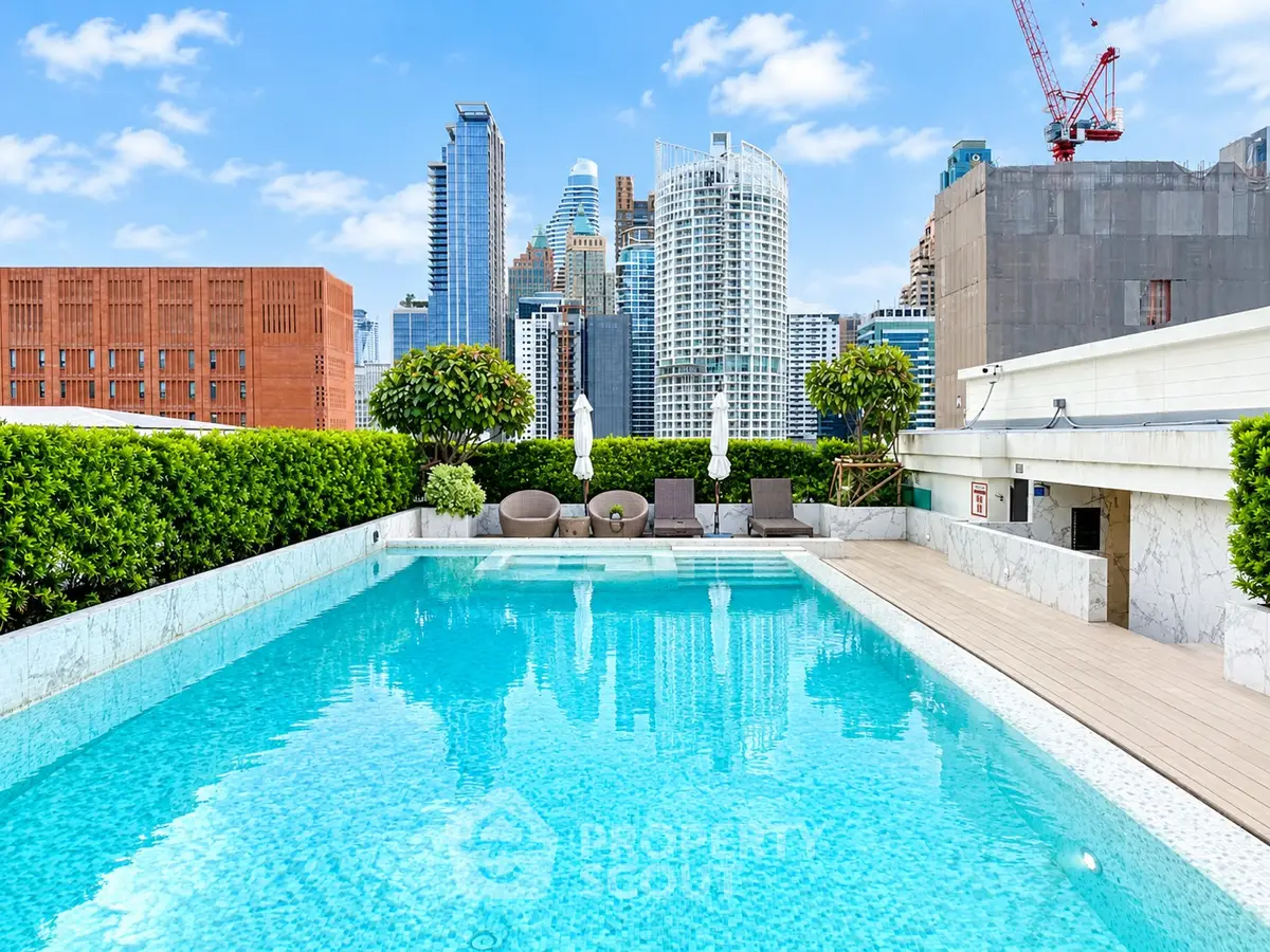 Luxurious rooftop pool with stunning city skyline views, perfect for relaxation and leisure in urban living.