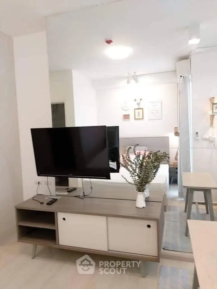Modern living room with sleek TV stand and stylish decor in a cozy apartment setting.