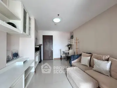 Modern living room with cozy sofa and dining area in open layout apartment.