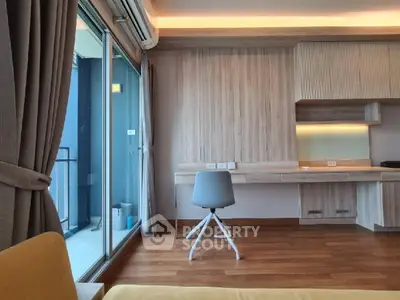 Modern study room with wooden flooring and balcony access