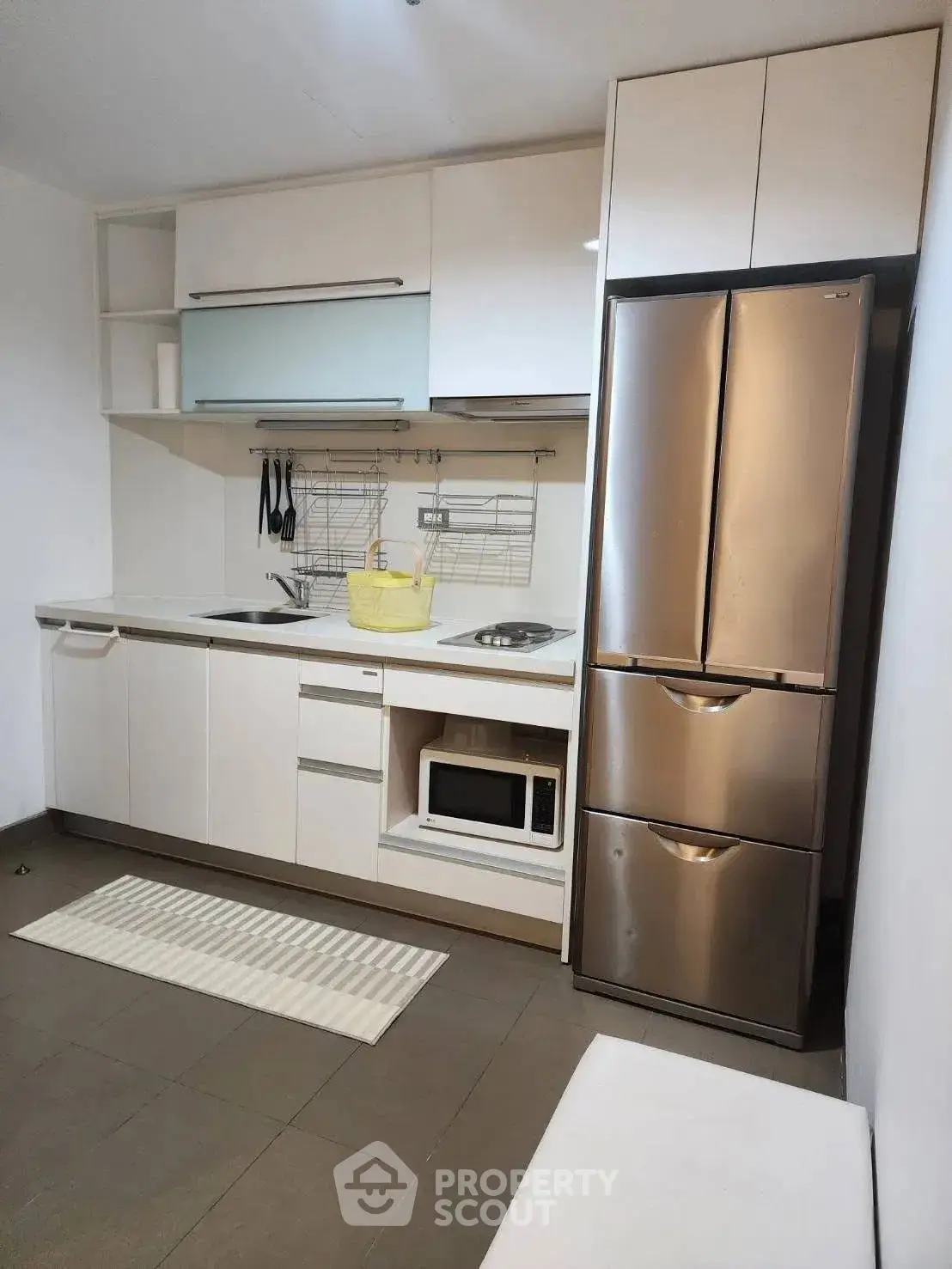 Modern kitchen with sleek cabinets and stainless steel fridge