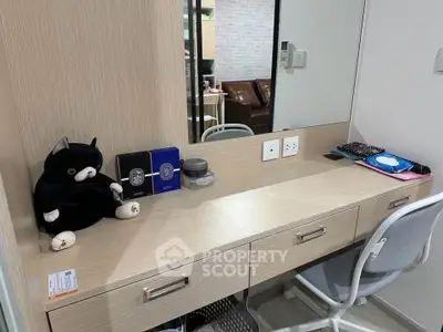 Modern study area with sleek desk and chair, featuring plush decor and ample storage.