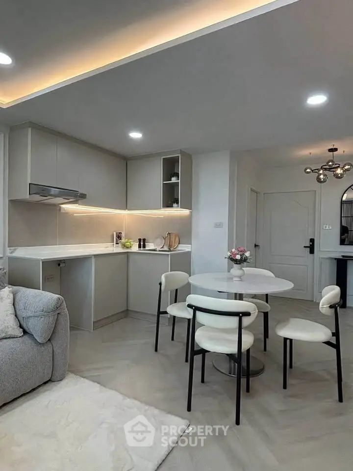 Modern open-layout kitchen and dining area with sleek design and cozy ambiance.