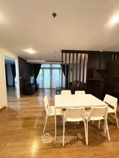 Spacious modern living room with wooden flooring and elegant dining area