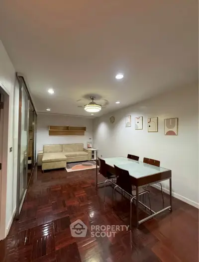 Spacious living room with modern dining area and cozy seating, perfect for entertaining guests.