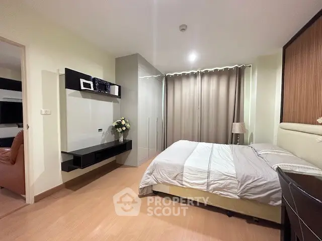 Modern bedroom with sleek design, featuring a cozy bed, built-in wardrobe, and elegant decor.
